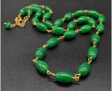 A Green Jade Small Cylinder Bead Necklace. Gilded clasp. 44cm 