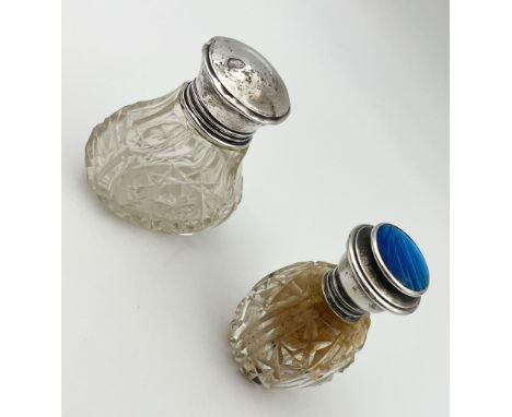 Two Silver-Topped Perfume Bottles - One with blue enamel. Hallmarks for Birmingham 1924. 7.5cm tall.300g total weight. 