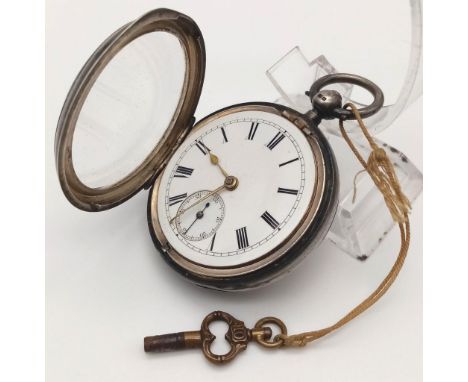 AN 1890'S SILVER POCKET WATCH WITH CHESTER HALLMARK, REAR WIND WITH KEY ,WHITE FACE WITH ROMAN NUMERALS. 