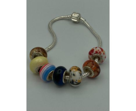 SILVER bracelet having Silver and enamel charms marked 925 silver. (22cm).
