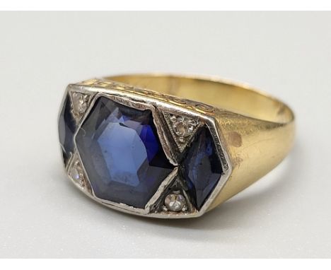 An 18 K yellow gold ring with three blue sapphires and four diamonds. Ring size: Q, weight: 7.6 g. 