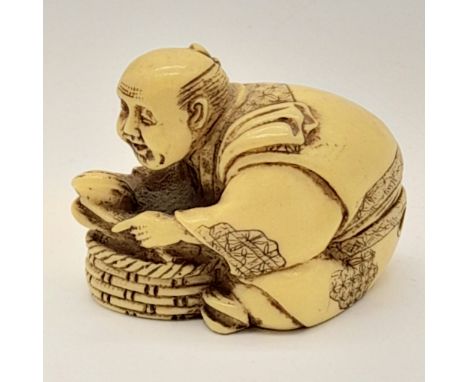 An antique Japanese carved ivory netsuke, in the form of an oyster catcher searching for pearls. Dimensions: 5 x 4 x 3,5 cm, 