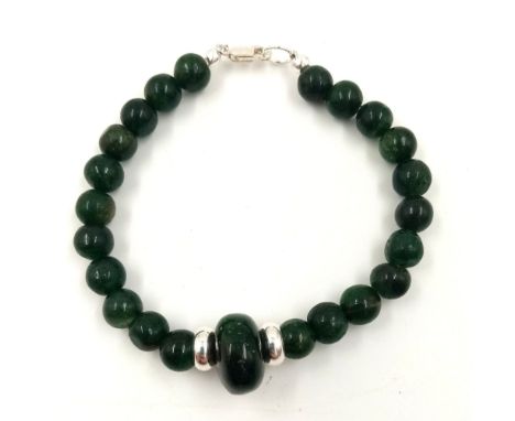 An African Jade 925 Silver Bracelet. 7mm jade beads with a large 15 x 10mm wheel central bead. Separated by 925 silver spacer