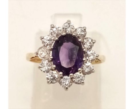 A 9K Yellow Gold Amethyst and White Stone Ring. Size K.2.06g 