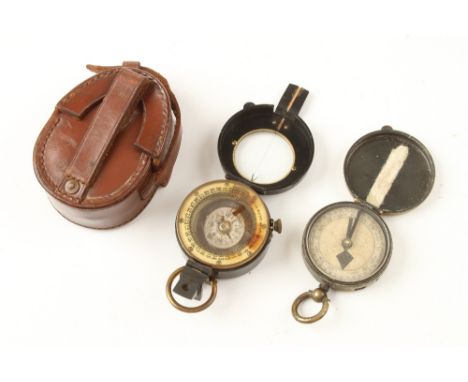 A prismatic compass in oil by J.H.STEWARD London (outer glass cracked) in orig leather case and another brass cased compass (