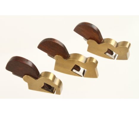 A pair of miniature brass flat and compass rebate planes 2 1/2" x 1/2" with rosewood wedges and a matching rebate plane 1 3/4
