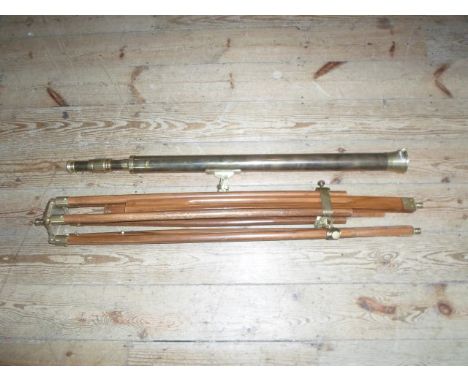A late 20th century gilt brass telescope and wooden tripod, 95cm unopened.