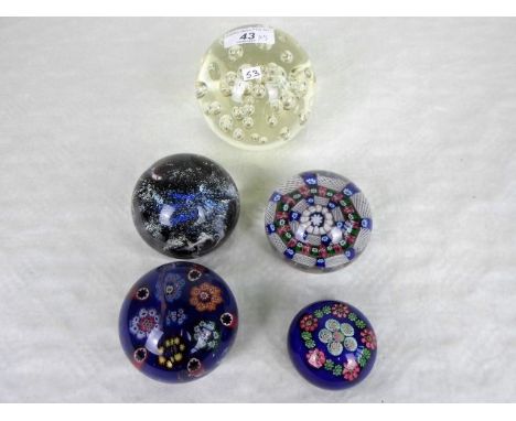 Five glass paperweights, to include an example by Caithness, the largest 10cm diameter.   Condition Report:  Bruise to the da