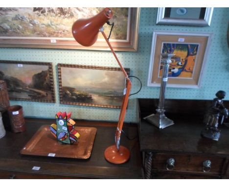 A mid to late 20th century orange painted angle poise desk lamp, the base 15cm diameter.