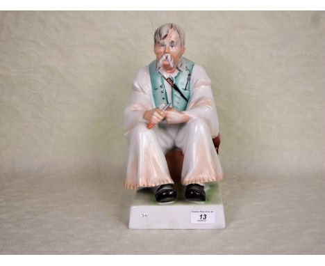 A large 20th century Zsolnay Pecs ceramic figure of a seated man, printed marks to base, 32cm.