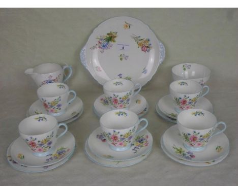 An early 20th century Shelley bone china part-tea service, in the Wild Flowers pattern, numbered 13668, comprising: six trios