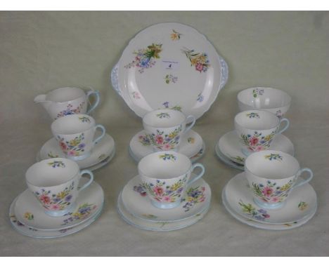 An early 20th century Shelley bone china part-tea service, in the Wild Flowers pattern, numbered 13668, comprising: six trios