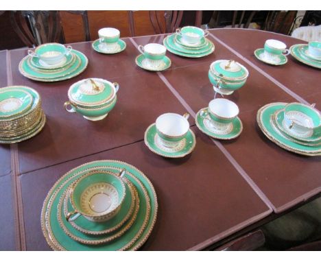 An extensive part-dinner service by Aynsley, pattern no. 7213, having a green band with gilt decorative border, the service c