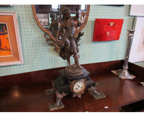 An early 20th century black slate French clock, having a bronzed figure surmount, titled 'Le Printemps', over a circular enam