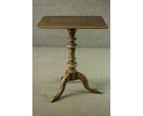 A fruitwood occasional table, with a square top, on a turned stem, with tripod feet. H.68 W.59 D.51cm. 