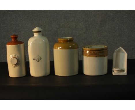 A collection of stoneware, including two Doulton Lambeth footwarmers, two food jars and a ceramic chamber stick. H.30cm 