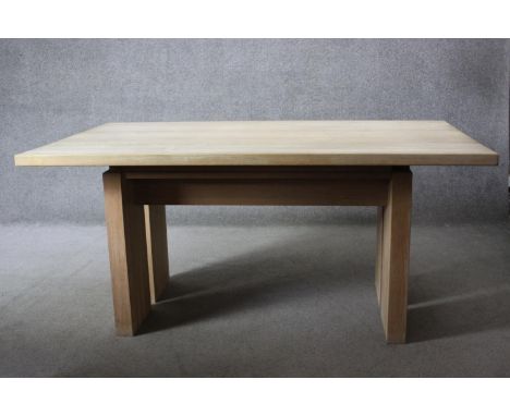 A contemporary light oak planked top dining table on block supports. H.74 W.160 D.100 cm. 