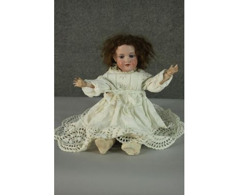A German Armand Marseille doll, Numbered 390, 19th century porcelain bisque head doll with glass eyes and plaster jointed lim