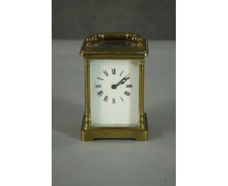 An early 20th century brass carriage clock, white enamel dial and black roman numerals. (No key) H.12 W.9cm 