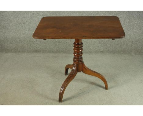 A 19th century mahogany tilt top table, with a rectangular top on a turned stem, on tripod feet. H.72 W.81 D.61cm. 