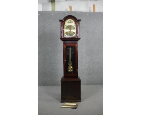 A mahogany longcase clock by Fenclocks, Suffolk. The brass arch dial inscribed ‘Tempus Fugit’ with glazed door. H.192 W.47 D.