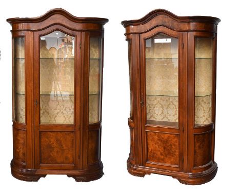 A Near Pair of Reproduction Walnut Display Cabinets, each with arched cornice above a central door, flanked by bowed glazed s