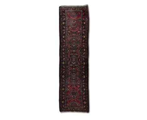 A PERSIAN SAROUK WOOL RUNNER, 295 x 80CMthe central field woven with repeating floral medallions in pink, green and blue tone