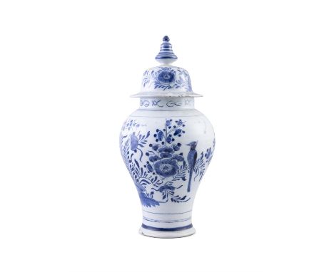 A DELFTWARE BLUE AND WHITE DECORATED CIRCULAR BALUSTER JAR AND COVER,with domed top and finial. 35cm high