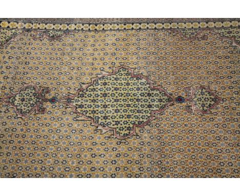 A PERSIAN INDIGO AND YELLOW GROUND WOOL CARPET, 207.5 X 137CMthe rectangular field woven with a large cartouche shaped panel 