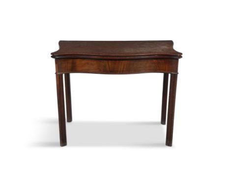 A GEORGE III MAHOGANY SERPENTINE FOLD TOP CARD TABLEthe solid panel top enclosing a green baize lined interior ,with  gate le