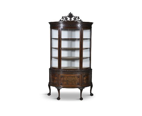 AN EDWARDIAN MAHOGANY BOWFRONT DISPLAY CABINET ON STAND the upper section, with dentil and blind fretwork frieze above a sing