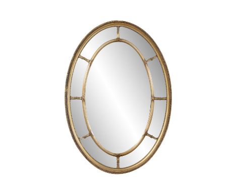 A GITLWOOD OVAL COMPARTMENTAL MIRROR,the outer frame with gadrooning and beading, enclosing an inner frame, glass plate with 
