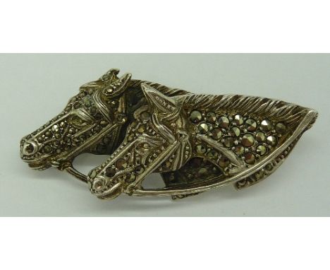 A vintage, c.1930, silver and marcasite brooch depicting two horses