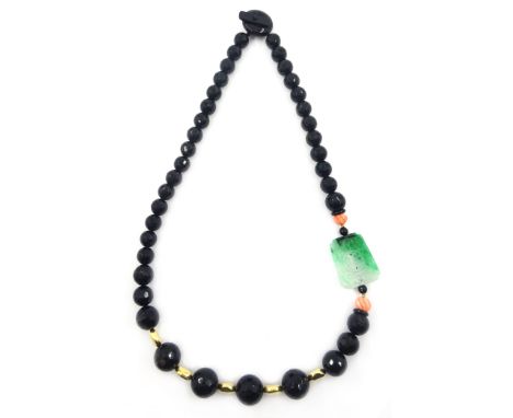 Carved jade, coral, black onyx and 18ct gold necklace Condition Report Length = 67cm, approx 155gm gold testedClick here for 