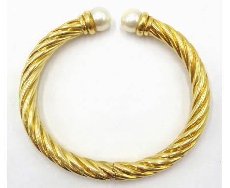 Gold rope twist hinged bangle, the open ends with pearl terminals hallmarked 18ct approx 25.3gm Condition Report Click here f