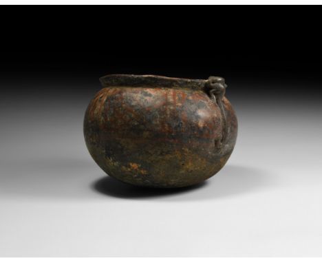 1st millennium AD. A globular ceramic bowl with chamfered rim to the mouth, rounded underside; red painted panels of latticew