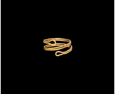 2nd millennium BC. A gold finger ring formed as a coil of parallel wires with loop finials, beaded detailing.  4.11 grams, 22