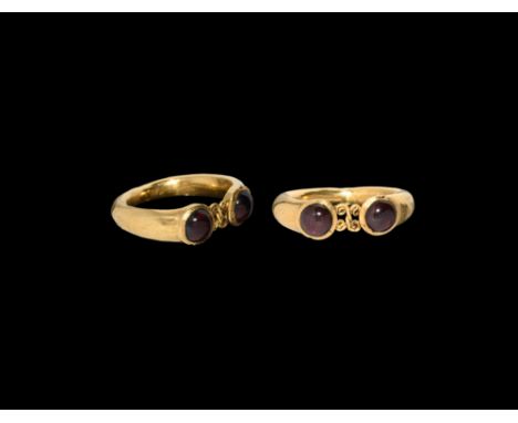 4th century AD. A hollow-formed penannular gold finger ring with two cabochon garnets.  3.39 grams, 26.25mm overall, 19.48mm 