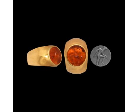 1st century AD. A carnelian discoid cloison with intaglio figure of Poseidon standing nude with one leg raised, set into a la