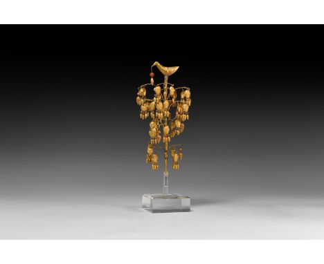 7th century AD. A sheet gold model tree with tubular trunk and beaded wire branches, hollow-formed pendant human masks with d