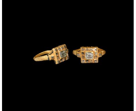 17th century AD. A gold finger ring with ribbed hoop keyed for enamel, square bezel with reserved flower to the underside on 