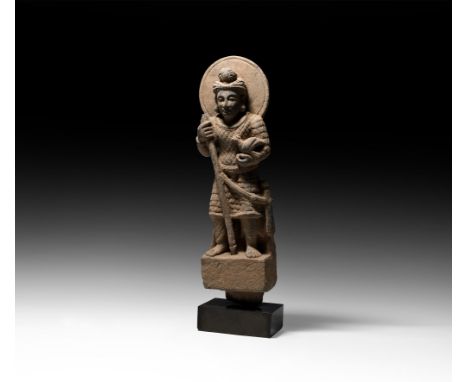 2nd-4th century AD. A carved schist figurine of a standing nimbate male wearing a quilted corselet of soft material as well a