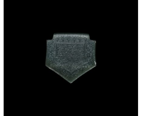 17th century AD. A carved jade pentagonal pendant with heater-shaped panel of nasta'liq text from the Qur'an on a field of re
