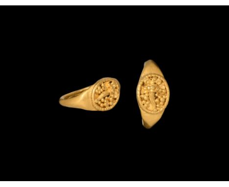 1st century AD. A gold finger ring with ellipsoid bezel, beaded wire collar and cornucopia in granulation. Cf. Chadour, A.B. 
