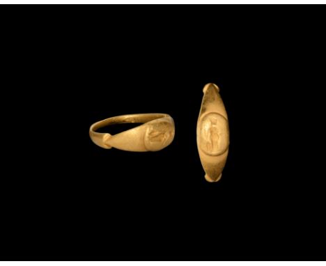 1st-2nd century AD. A gold finger ring with stepped shoulders, ellipsoid domed bezel with intaglio Minerva standing with helm