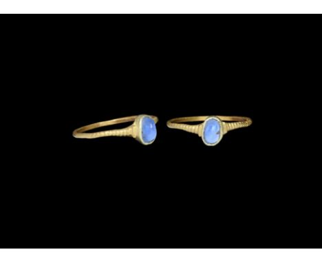 13th-14th century AD. A gold D-section hoop with ribbed shoulders, oval cup bezel with inset light blue sapphire. Property of