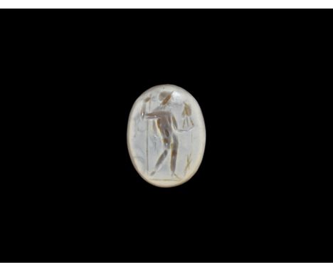 2nd century AD. An ellipsoid calcified sard plaque with intaglio standing Mars holding a spear in one hand and helmet(?) in t