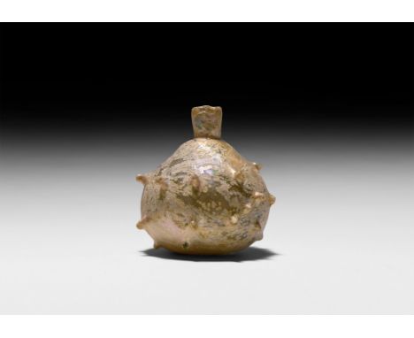 3rd-4th century AD. An iridescent globular glass flask with vertical rows of pinched protrusions. See Christie’s London, Alfr