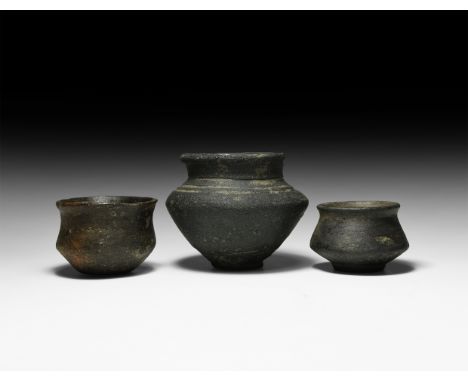 5th-6th century AD. A group of three unglazed ceramic vessels comprising two jars each with rounded rim and carination to the