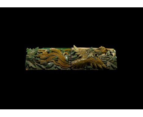 Late Ming Dynasty, 16th-17th AD. A pair of glazed ceramic wall tiles depicting a fenghuang in flight among foliage.  27.3 kg 
